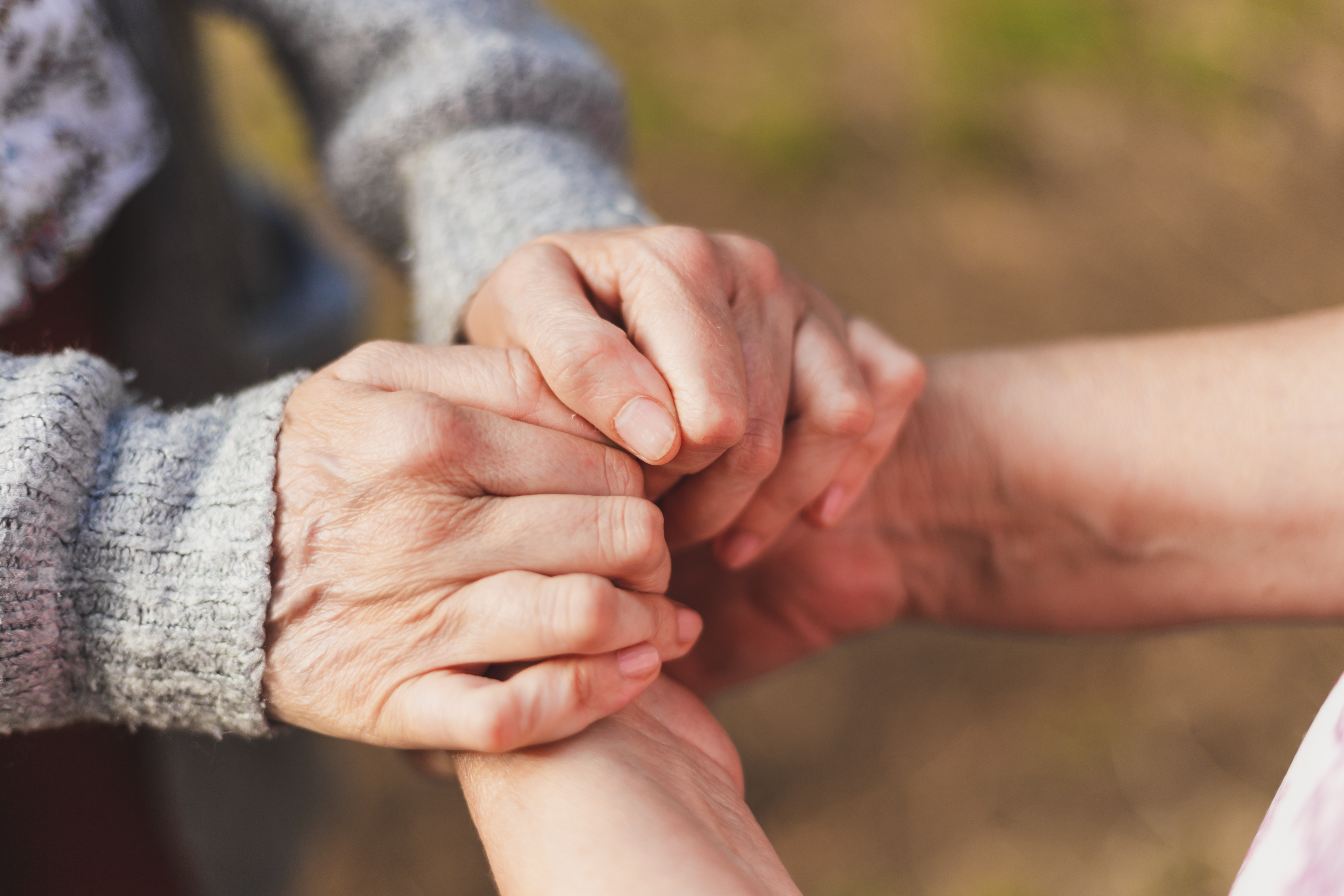Niece holding granny's hands
